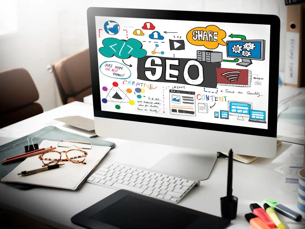 tela de um computador com ícones referentes a makerting digital, blog e com a palavra SEO em destaque